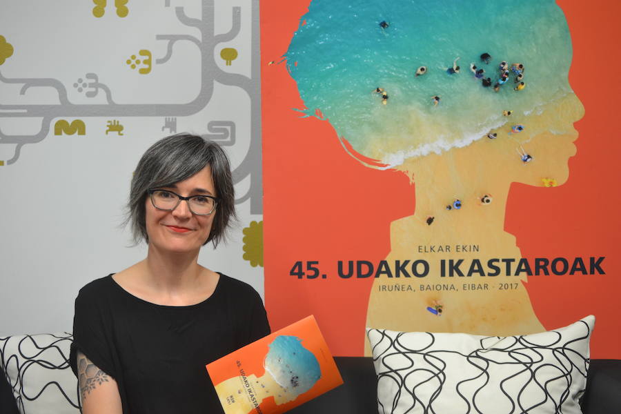 Irati Iciar Udako Ikastaroen arduraduna, 45. edizioko kartelaren aurrean.