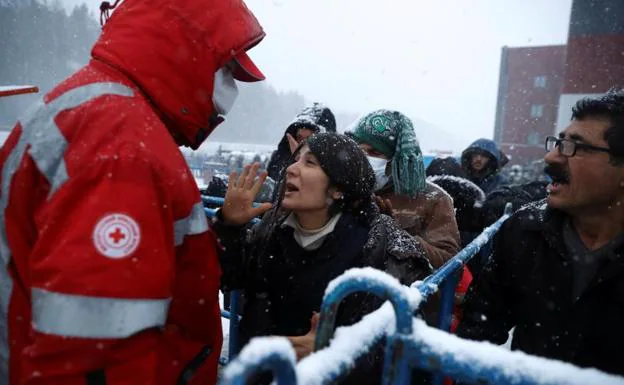 Migrants gathered at a transport and logistics center in the Belarusian region of Grodno, speak with a member of the Red Cross. 