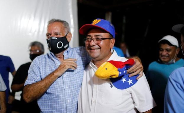 Sergio Garrido, right, celebrates the victory with one of his supporters.