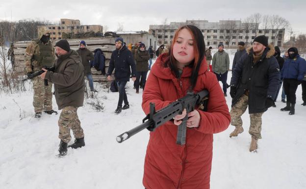 A young woman practices combat with a civilian militia during military training in Ukraine. 