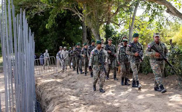 Dominican soldiers patrol during the inauguration of the wall. 