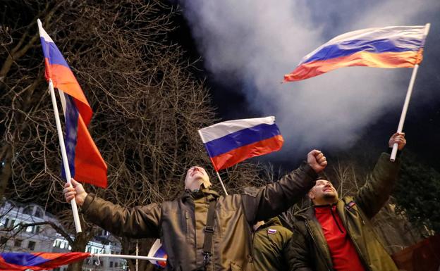 Celebrations in the streets of Donetsk with Russian flags.