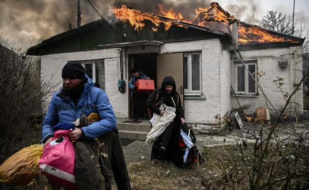 Abandonment.  A Ukrainian family leaves their home in Irpin, Kiev, behind after a fire started in it due to shelling.