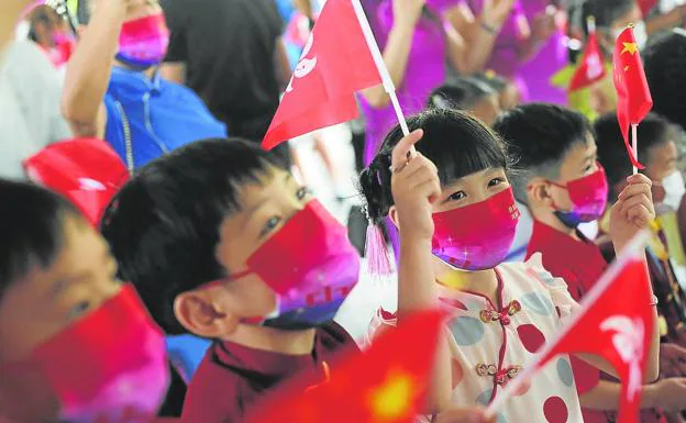 Children in traditional Chinese costumes take part in a ceremony marking the 25th anniversary of Hong Kong's handover to China.