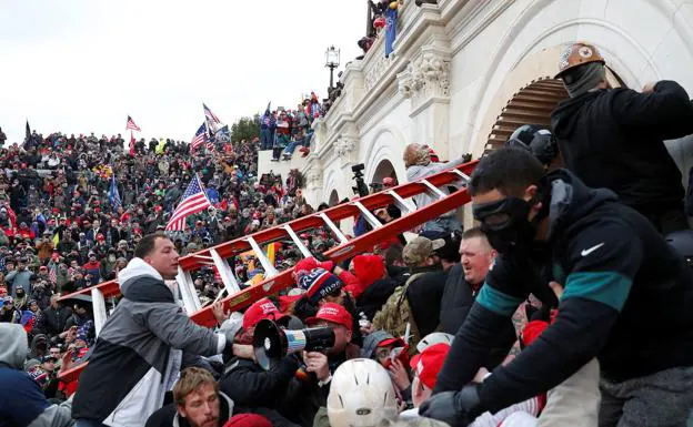 A mob storms the Capitol on January 6, 2021. 