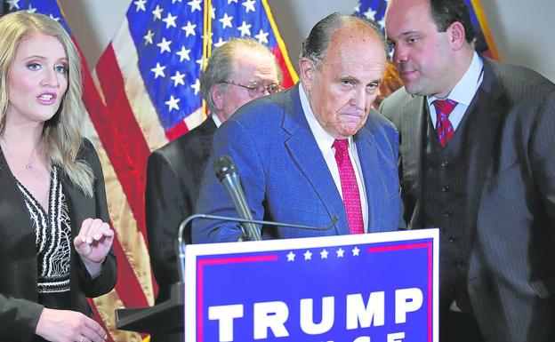 Rudy Giuliani, with a grim gesture, at a press conference after Trump's electoral defeat.