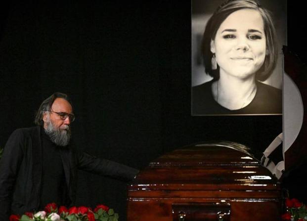 Russian philosopher Alexander Dugin weeps at the coffin of his daughter. 