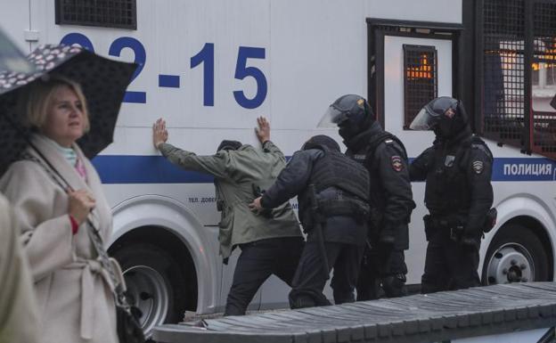 Police arrest a protester in central Moscow. 