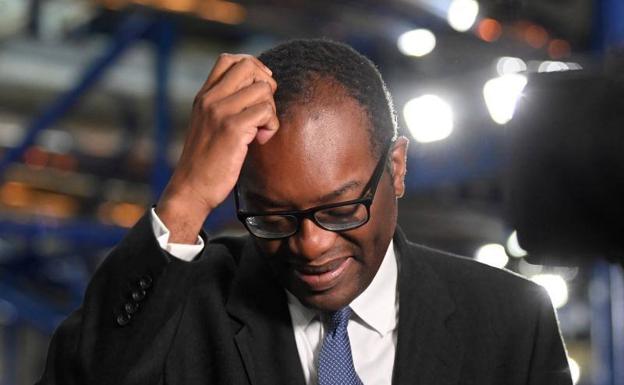 British Chancellor of the Exchequer, Kwasi Kwarteng, gestures during a television interview on Monday.