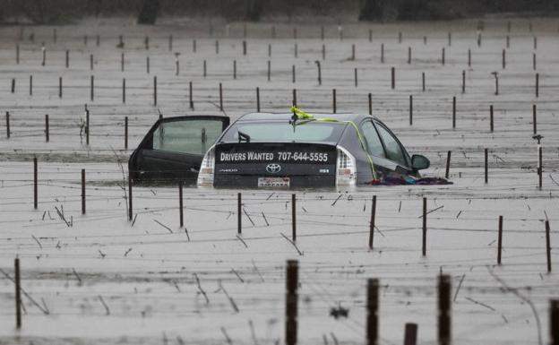 A car submerged and abandoned by floodwaters near a vineyard in Forestville, California. 